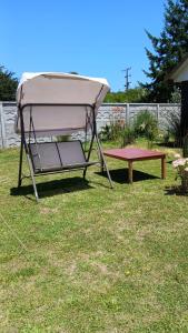 a gazebo and a picnic table in a yard at CostaMonkul in Nahuentúe