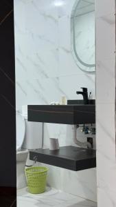 a bathroom with a sink and a toilet and a mirror at Wadi Rum party luxury camp in Disah
