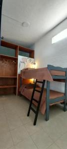 a room with a table and a bunk bed at La Casita de Oreste in Cosquín