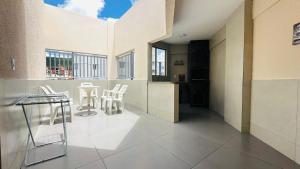 a room with chairs and a table in a building at Thermas Paradise Apartamentos Rio Quente Esplanada in Rio Quente