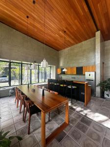a dining room with a large wooden table and chairs at Clover Bentota in Dedduwa