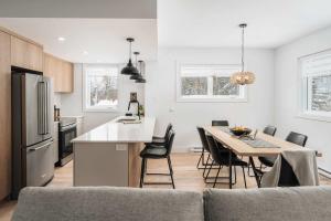 a kitchen and dining room with a table and chairs at Mont Blanc 121-111 in Saint-Faustin