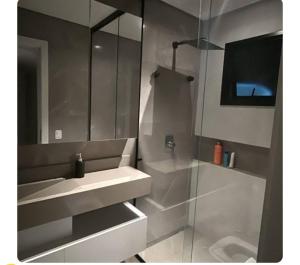 a bathroom with a sink and a shower at Casa de luxo com piscina in Florianópolis