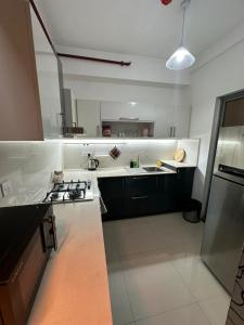 a kitchen with a sink and a stove top oven at Oval View Residencies By C in Colombo