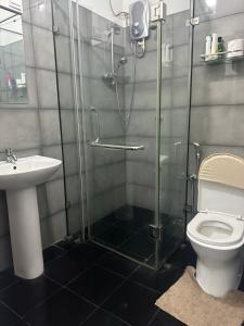a bathroom with a shower and a toilet and a sink at Oval View Residencies By C in Colombo