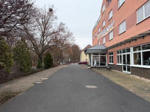 an empty street in front of a building at Hotel BernsteinSee in Bitterfeld