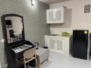 a kitchen with a black refrigerator and a table at Dailyroom C3,C4by Anna in Nonthaburi