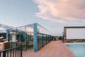 a building with glass doors and a swimming pool at Hotel Parangvue in Goseong +120 photos