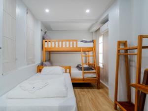 a small room with a bed and bunk beds at ขนอม คิริณณ์ Khanom Kirin Private Pool Villa in Ban Plau +18 photos