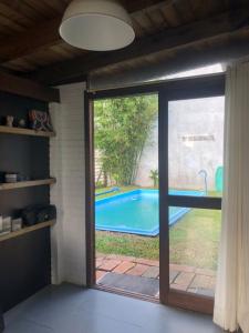 a sliding glass door with a view of a swimming pool at Casa rústica in Torres