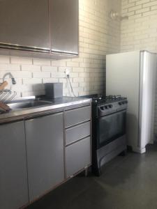 a kitchen with a stove and a refrigerator at Casa rústica in Torres