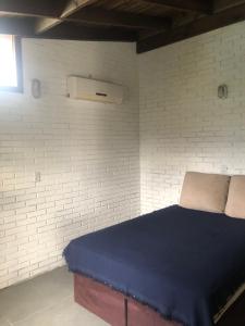 a bedroom with a bed in a white brick wall at Casa rústica in Torres +10 photos