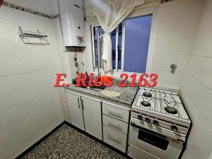 a small kitchen with a stove and a window at Dos ambientes plaza colon in Mar del Plata