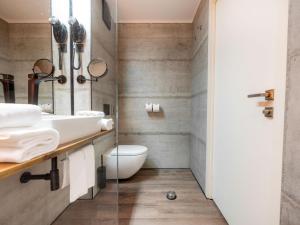 a bathroom with a sink and a toilet at Hotel City Maribor in Maribor