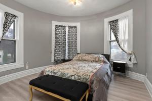 a bedroom with a bed and two windows at The Palace in Rockford