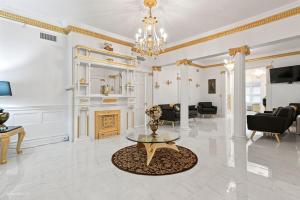 a large living room with a chandelier and a table at The Palace in Rockford