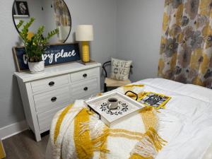 a bedroom with a bed with a table and a mirror at Chic Retreat in Sebring