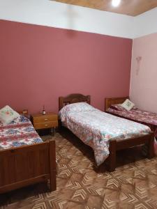 a room with two beds in a room at Cabaña La Anita in Cosquín