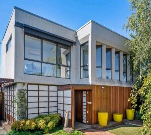 a house with large windows and a wooden door at Entire Studio in Moonee Ponds with Free Parking in Melbourne