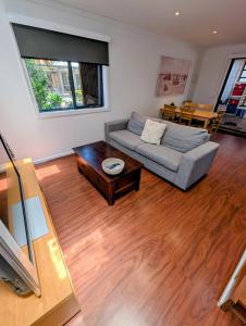 a living room with a couch and a coffee table at Entire Studio in Moonee Ponds with Free Parking in Melbourne