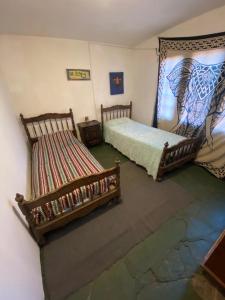 een slaapkamer met 2 bedden in een kamer met bij Kuku hostel in Las Rabonas