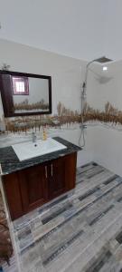 a bathroom with a sink and a mirror at Negombo Villa in Negombo