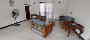 a living room with a couch and a table at Negombo Villa in Negombo