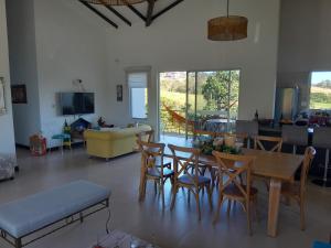 a living room with a table and chairs and a couch at CASA CAMPESTRE COMPLETa in Barbosa