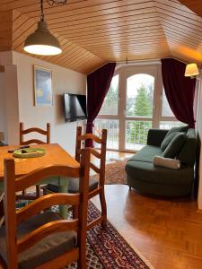 a living room with a table and a couch at Villa am Goldbach in Bad Aibling