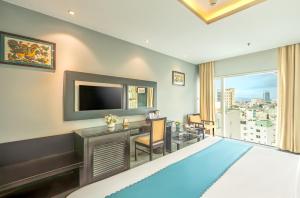 a hotel room with a large bed and a television at Chill Hotel Ha Bong in Danang