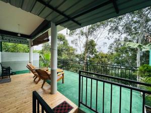 a balcony of a house with a table and chairs at The Bliss Homestay in Ella