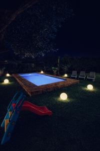 een zwembad in een tuin 's nachts met verlichting bij Luxury Villa with Pool & Garden5km from Cabo in Tetouan