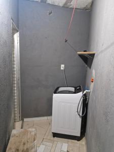 a corner of a room with a heater and a wall at Próximo a roda gigante in Maceió