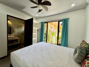 a bedroom with a bed and a ceiling fan at Lillitica in Cocles