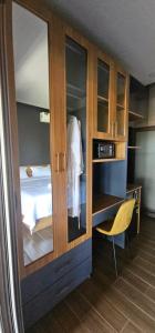 a room with a bedroom with a bed and a cabinet at Palisade Garden in Ấp Thiện Sơn