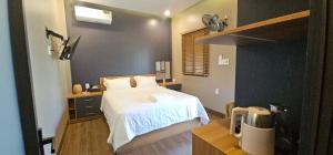 a bedroom with a bed with a white bedspread at Palisade Garden in Ấp Thiện Sơn