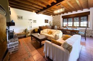 a living room with two couches and a table at Moulin gratia in Lay-Lamidou