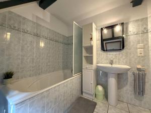 a bathroom with a sink and a bath tub and a sink at Moulin gratia in Lay-Lamidou +32 photos