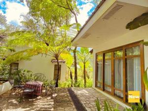 a patio of a house with chairs and tables at Baluarte Rest and Relaxation in Sampong