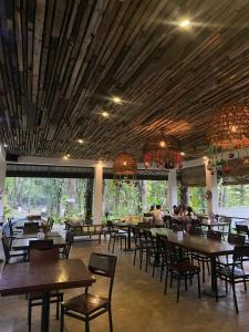a dining room with tables and chairs and chandeliers at Baluarte Rest and Relaxation in Sampong