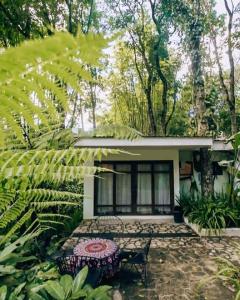 a house with a table and a bench in front of it at Baluarte Rest and Relaxation in Sampong
