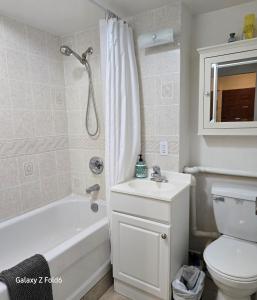 a bathroom with a tub and a toilet and a sink at Wallace getaway in Delta +30 photos