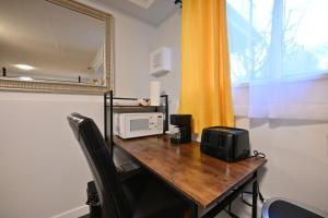 a wooden table with a microwave and a mirror at Vancouver UBC 2BD Suite in Vancouver