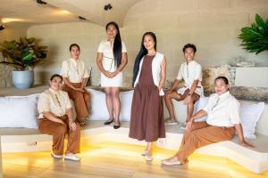 a group of people posing for a picture in a room at Encantada Residences in Boracay +16 photos