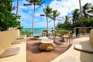a patio with a table and chairs and the ocean at Encantada Residences in Boracay