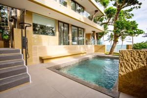 a swimming pool in front of a house at Encantada Residences in Boracay