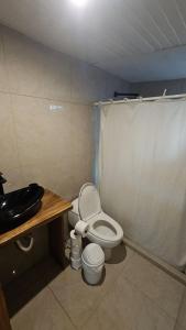 a small bathroom with a toilet and a sink at KAIA VILLAGE, Santa Teresa, Costa Rica in Santa Teresa Beach