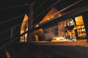 a table with a glass of wine and a plate of food at OENO WINE LODGE Valle de Guadalupe in Valle de Guadalupe +82 photos