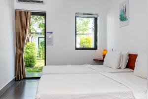 a white room with three beds and a window at Onederz Koh Rong in Koh Rong