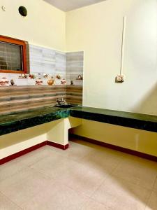 a room with a counter with a sink in it at Koraput Crown Homestay in Similigurha